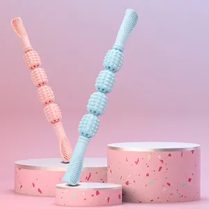 Pink and blue foam roller muscle massager sticks for leg stretching and relaxation