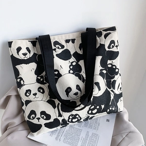 Close-up of wide nylon handles and cute panda patterns on a large canvas tote bag