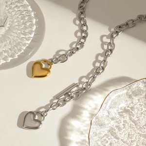 Stainless steel heart pendant necklace with gold and silver link chain and T-bar clasp