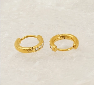 Close-up of 18K gold-plated titanium earrings with sparkling clear zircon stones