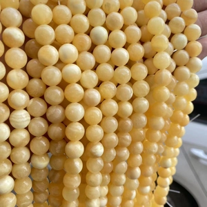 Natural yellow jade beads for jewelry making with smooth waxy texture and creamy finish