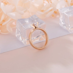 Elegant rose gold solitaire ring with 4mm round cubic zirconia in a 4-claw setting