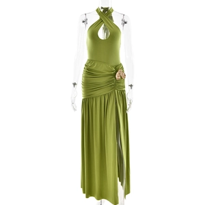 Detail of green halter dress with chest cutout, gold buckle, and high side slit feature