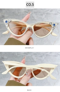 Detail of cat-eye sunglasses with cream frames and hand-set diamond chain rhinestones