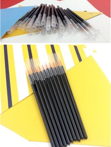 Detail of fine tip eyeliner brushes with orange nylon bristles and transparent caps