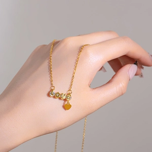 Gold plated love letter necklace with sparkling crystals and heart tassel pendant