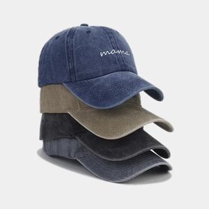 Close-up of four stacked vintage washed cotton baseball caps with mama embroidery
