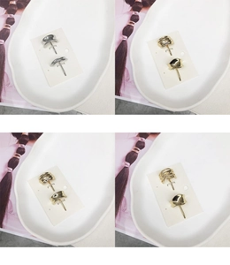 Detailed macro view of minimalist gold and silver wavy geometric alloy ear studs