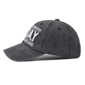 Macro view of washed gray vintage baseball cap with white Origins Day 1985 embroidery