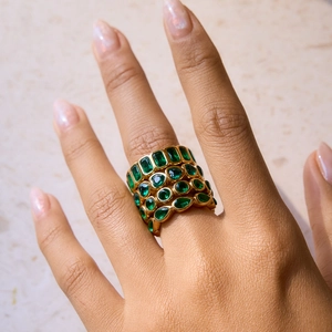 Stacked 18k gold plated stainless steel rings featuring emerald green zircon gemstones
