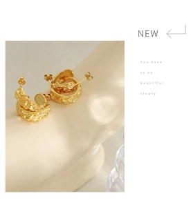 Detailed view of 18K gold plated C-shape earrings with a unique hammered metal texture