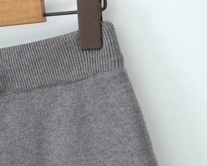 Detailed macro view of the grey ribbed knit elastic waistband on a slim fit skirt