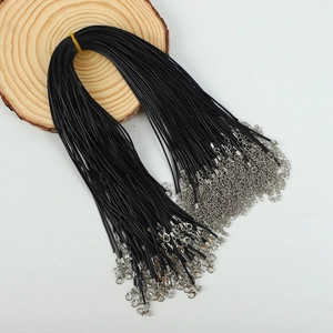 Bulk black waxed cord necklaces with silver lobster clasps and extension chains on wood