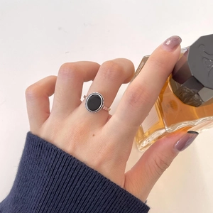 Detailed close-up of a vintage 925 silver ring featuring a large oval black agate stone