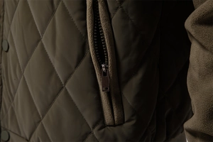 Detail of diamond-quilted jacket featuring a metal zipper and fleece trim accents