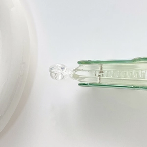 Detailed close-up of light green acrylic hair clip teeth and spring mechanism