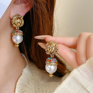 French palace style lion head earrings with sparkling diamonds and white pearls
