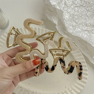 Three-piece set of wavy acrylic hair claws in pearl white, nude, and tortoiseshell finish