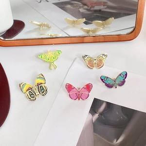 Set of five colorful butterfly enamel pins with vibrant patterns and alloy metal finish