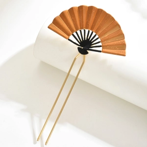Golden fan-shaped hair stick with black accents and dual prongs for women's traditional updos