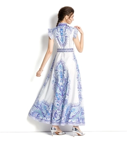 Rear view of long white A-line dress with blue paisley print and ruffled sleeve details