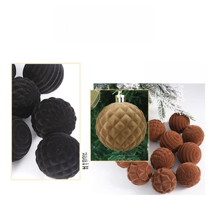 Detail of flocked Christmas ornaments showing velvet texture and embossed patterns