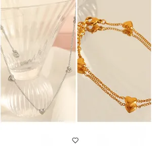 Detail showing gold double-layer chain and silver minimalist heart pendant jewelry set