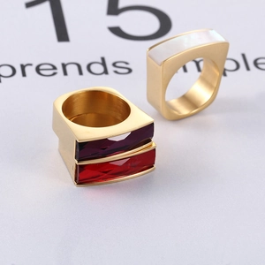 Macro shot of gold stainless steel geometric rings with colorful square gemstones