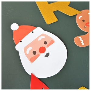 Detail of Christmas paper banners featuring Santa, gingerbread man and festive letters