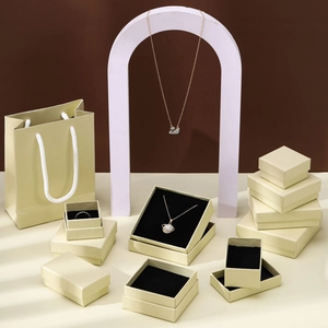 Minimalist beige jewelry gift box set with matching paper bags for rings and necklaces