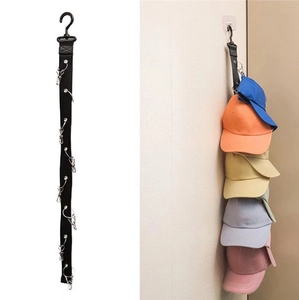 Detail of wall-mounted black hat organizer strap with ten stainless steel clips