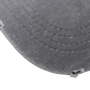 Detail shot of distressed gray washed cotton baseball cap brim with stitching