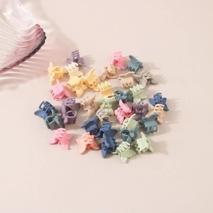 Macro shot of colorful mini matte hair claws in various macaron pastel shades