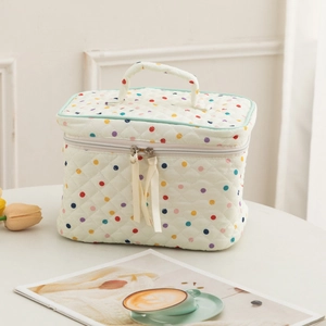 Quilted cotton makeup bag with colorful polka dots, top handle and ribbon zipper