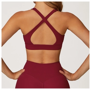 Macro shot showing the criss-cross back design of the burgundy high-elastic sports bra