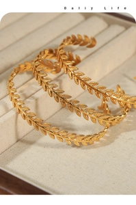Macro shot of gold-plated titanium steel bracelet featuring detailed wheat ear engravings