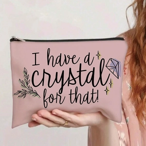 Detail of a pink canvas makeup bag with I have a crystal for that print and zipper