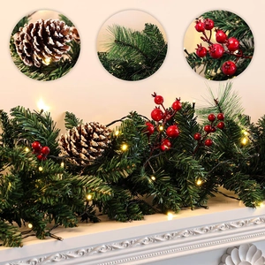 2.7m Christmas garland with LED lights, pine cones and red berries on a white fireplace