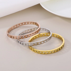 Detailed macro of hollow chain pattern bangles in rose gold, silver and gold finishes