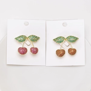 Close-up of elegant cherry brooches with micro-set green and pink cubic zirconia