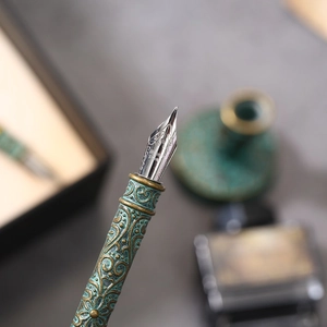 European vintage bronze feather quill pen set with ornate embossed metal grip and nib