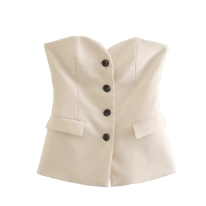 Detail view of the cream white strapless vest top with four dark buttons and pockets