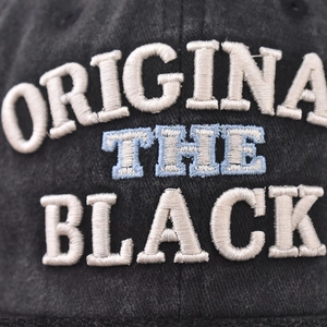 Vintage washed black cotton baseball cap with THE BLACK 3D embroidery and denim texture