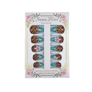 Leopard print almond press-on nails with 3D pink resin flowers and green accents