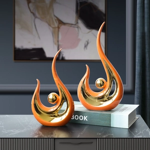 Modern abstract ceramic phoenix sculptures in vibrant orange and gold for living room decor