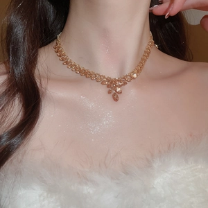 Macro shot of gold zircon wheat ear necklace featuring delicate leaf link tassel pendant
