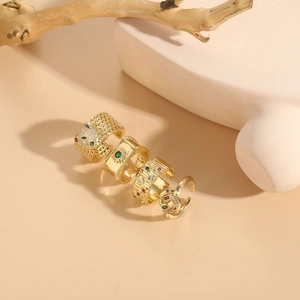 Detailed view of four 14K gold plated geometric rings with colorful zircon gemstones