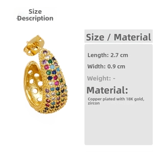 Macro detail of gold-plated C-shaped earrings showing dimensions and colorful zircons