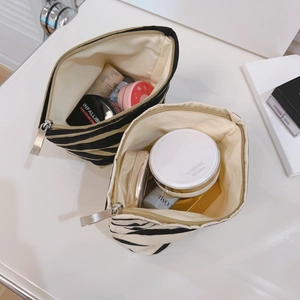 Striped canvas makeup bag set with durable metal zipper and spacious interior for cosmetics
