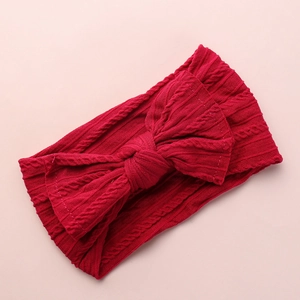Detailed view of a red baby nylon headband featuring a large jacquard bow texture.